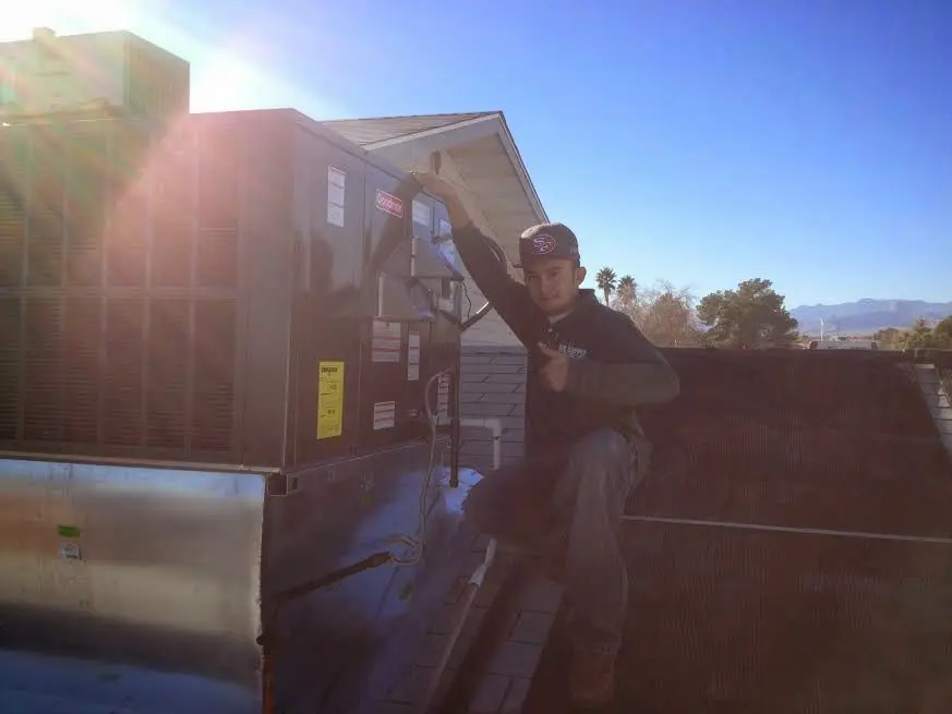 HVAC technician performing HVAC Inspection on a rooftop unit in Catonsville